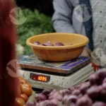 Seller Putting Vegetables in a Bag- Log, Colour and B&W