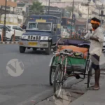 Rickshaw Puller Fixing His Shirt - Log, Colour and B&W