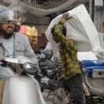 Ola Scooter and a Man Carrying a Package - Log, Colour and B&W