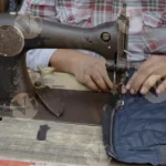 Sewing Machine Man in front a shop - Log, Colour and B&W