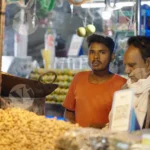 Roasted Peanut Seller having a conversation - Log, Colour and B&W