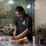 Man Cutting Garlic Naan - Log, Colour and B&W