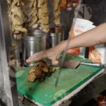 Man Taking out Chaap from Skewer - Log, Colour and B&W