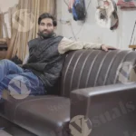 Man sitting on the sofa - log, colour and B&W