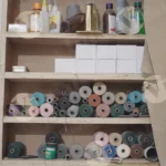A shelf that holds a variety of threads and tapes - Log, colour and B&W