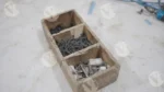 A wooden storage container with nails and screws - Log, colour and B&W