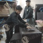 Workers assembling sofa wide shot - Log, colour and B&W