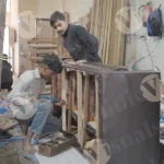 Workers are putting nails on the sofa with a drill machine - Log, colour and B&W
