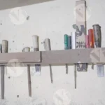 A set of woodworking tools on a shelf, tools include chisels, gouges, and hand tools - Log, colour and B&W