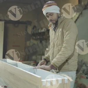 Carpenter tapping plywood shelf wide shot - log, colour and B&W