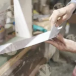 Man gluing plywood - log, colour and B&W