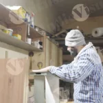 Carpenter is gluing wood - log, colour and B&E