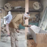 Carpenter hammering shelf - log, colour and B&W