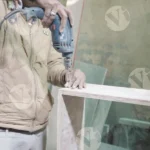 Man assembling wooden piece - Log, colour and B&W