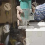 Carpenter cutting plywood with a machine - log, colour and B&W