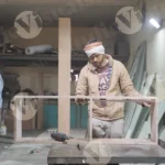 Carpenter measuring plywood - log, colour and B&W