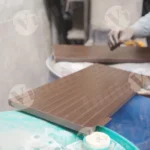 Carpenter polishing plywood - log, colour and B&W