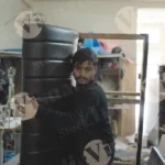 Man carrying half made sofa - log, colour and B&W