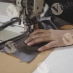 Man sewing leather cloth - log, colour and B&W