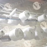 Multiple Spools of White Yarn Arranged on a Rack - Log, colour and B&W