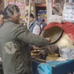Seller selling chhole kulche - Log, colour and B&W