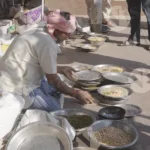 Man selling brid feed - Log, colour and B&W