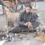 Cobbler polishing shoes on street - Log, colour and B&W