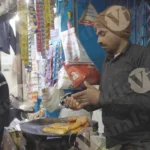 Man Making Aloo Tikki on the Street - Log, colour and B&W