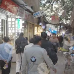 People walking on a busy street - Log, colour and B&W