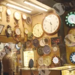 Watch store with a variety of clocks and watches displayed - Log, colour and B&W