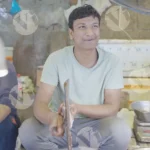 Man cleaning fish - Log, colour and B&W