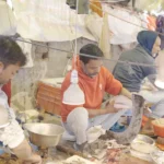 Man cutting fish - Log, colour and B&W
