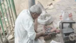 Elderly man, street cobbler, repairing shoes - Log, colour and B&W