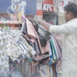 Man Selling Clothes on The Street - Log, colour and B&W