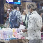 A Man Selling Mini Hand Fan - Log colour and B &W