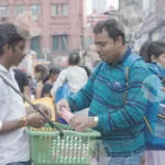 Man is Selling Water Bottle on Street - Log, colour and B&W
