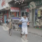 A Man Pulling a Rickshaw on a Street - Log, colour, and B&W
