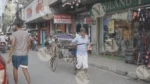 A Man Pulling a Rickshaw on a Street - Log, colour, and B&W