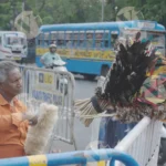 A Man using a feathers Duster to Clean - Log, colour and B&W