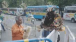 A Man using a feathers Duster to Clean - Log, colour and B&W