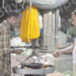 A Coustomer Buying Samosa - Log, colour and B&W