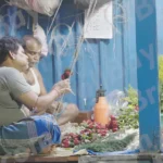 A Man Making Flowers Garland - Log, colour and B&W