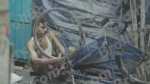 A Man Repairing a Bicycle - Log, colour and B&W