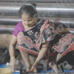 A Woman Cutting Meat - Log, colour and B&W