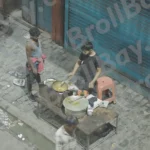 Boy Making Food on Street - Log, colour and B&W