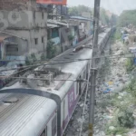 A Train Passing Through a Densely Populated Slum Area - Log, colour and B&W