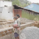 A Man is Standing and he has a Child in his Arms - Log, colour and B&W