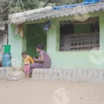 A Woman Sitting Outside her House and a Child is Playing - Log, colour and B&W