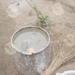 A Metal Bucket Filled with Water Sitting in The Ground - Log, colour and B&W