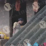 A Woman Standing in the Doorway of a Simple Tribal House - Log, colour and B&W